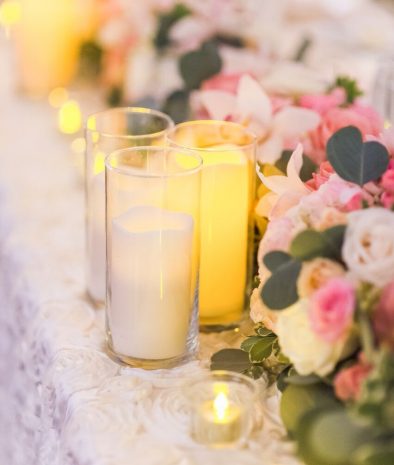 flowers lining table with candles