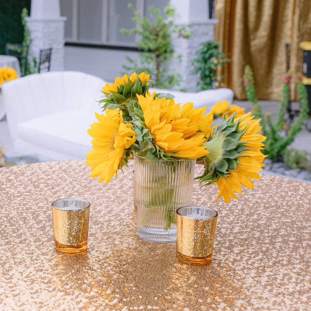 Sunflower floral centerpiece on gold sequin table linen designed by Miss Daisy Flowers for a Las Vegas garden party.