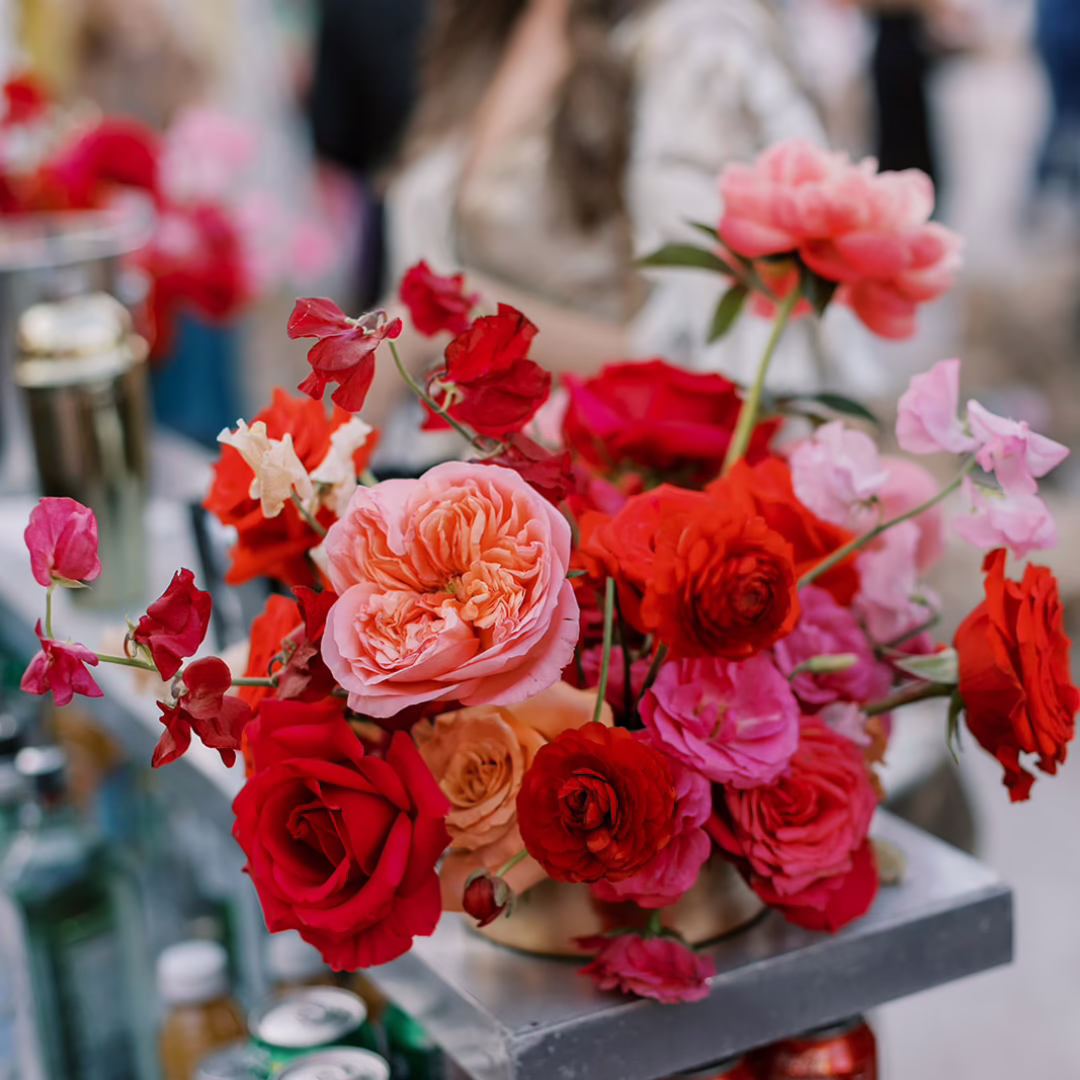 Vibrant red and pink flower arrangement at the cocktail bar during a wedding welcome reception at the Neon Museum Las Vegas